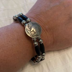 Silver and black beaded bracelet with buffalo coin pendant